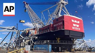 Salvage crews begin removing containers from ship that collapsed Baltimore bridge