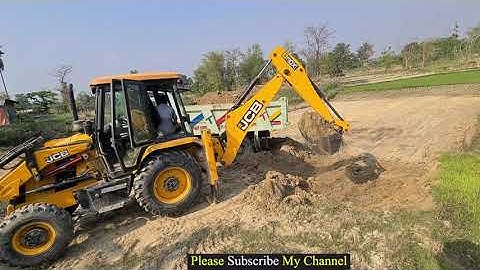 Jcb leveling land loading soil in heavy truck