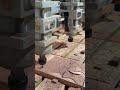 the process of carving on several pieces of wood to create a motif using tools in the factory