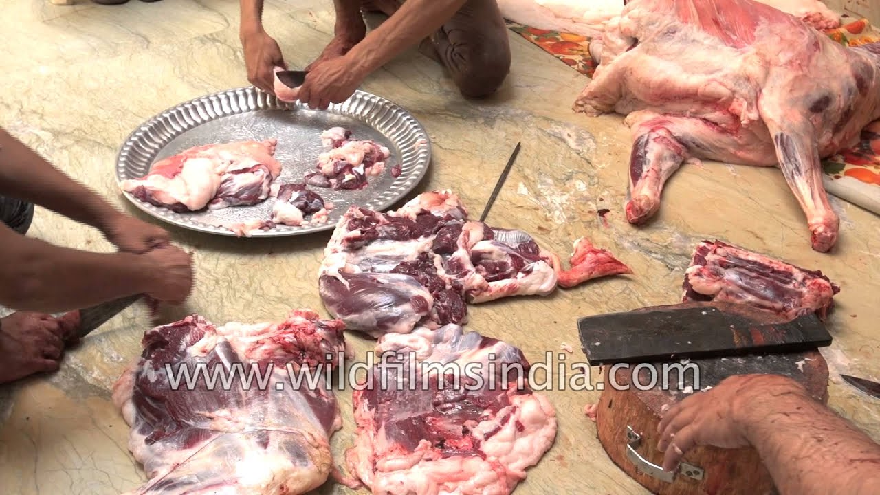 Chopping goat meat into pieces during Eid al-Adha, India 