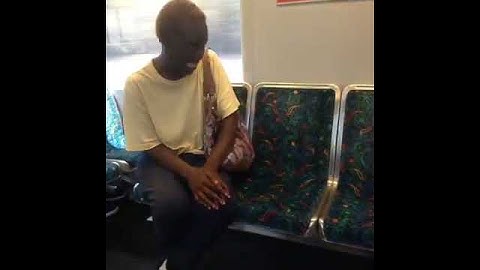 Woman talking to herself on subway