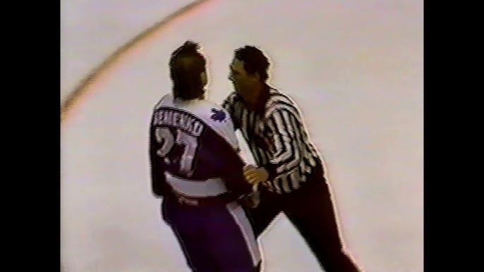 Kings' Rick Lapointe turtles under imminent threat of a Dave Semenko punch.