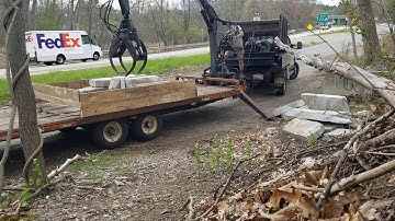 Unloading granite with log grapple
