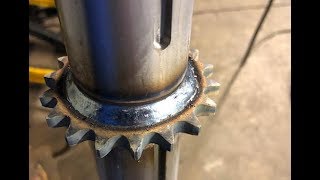 Welding hardened sprocket to shaft with dual shield