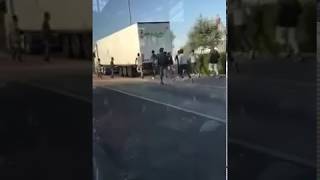 Migrants seen chasing after lorry