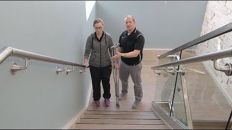 Crutch use: Ascending stairs with a handrail