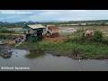 Truck dumping soil into ponds to make room for construction of fish pond guardhouses.