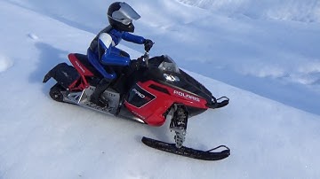 Rc snowmobile polaris rush brushless jumping on track.