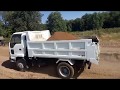 Isuzu Forward 96 loading a dump truck on a sand quarry