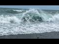The Raw Power of the Ocean: Crashing Wave on a Dark Pebbled Shore