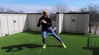 Banded squat hold into lateral toe taps