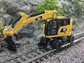 Produktpräsentation  Zweiwegebagger Eisenbahnbagger Gleisbagger Cat Caterpillar Diecast Masters - H0