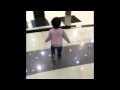 Little girl walks into glass door