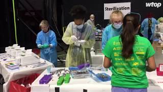 Inside arena, dentists and hygienists serve a Mission of Mercy