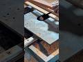 cutting a large piece of wood into multiple sections using a heavy vertical electric saw machine