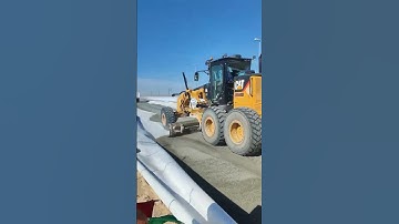 Road Construction By Motor Grader Pushing And Grading Gravel