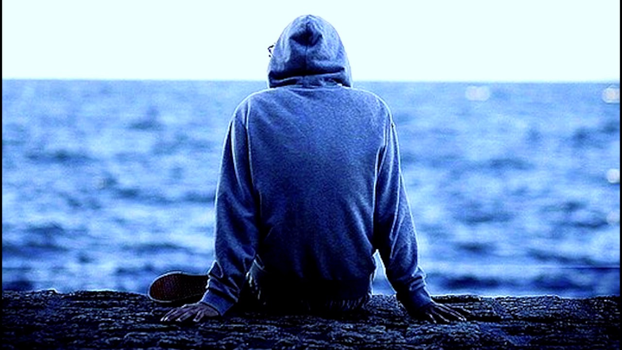 Парень в капюшоне возле моря