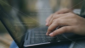 Closeup of woman hands typing at laptop outdoors