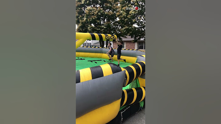 Boy gets hit on face playing on the inflatable rotating obstacle game || WooGlobe