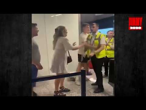 A furious vacationer knocked two workers to the ground in a queue at the airport