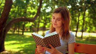 girl reading a book in nature 4k
