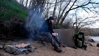 Bushcraft and fishing on the river bank in spring