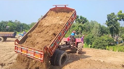 Soil unloading by digital system hydraulic tractor unload soil facilities on over rough hills