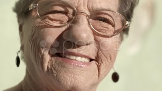 Elderly Woman With Glasses Smiling And Looking At Camera. Stock Footage