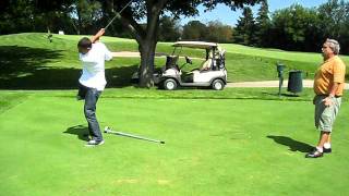 Asael Shabo getting a golf lesson from Mike Frazin at ISCD Golf Classic at Twin Orchard