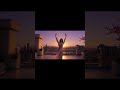 A Woman Dances Gracefully on a Sunset Balcony