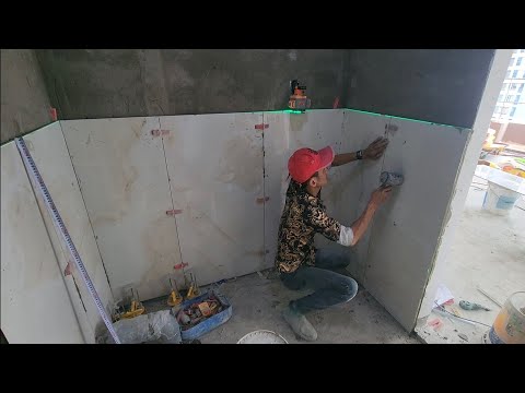 quá trình thi công ốp gạch 60x120 ốp đứng tường toilet