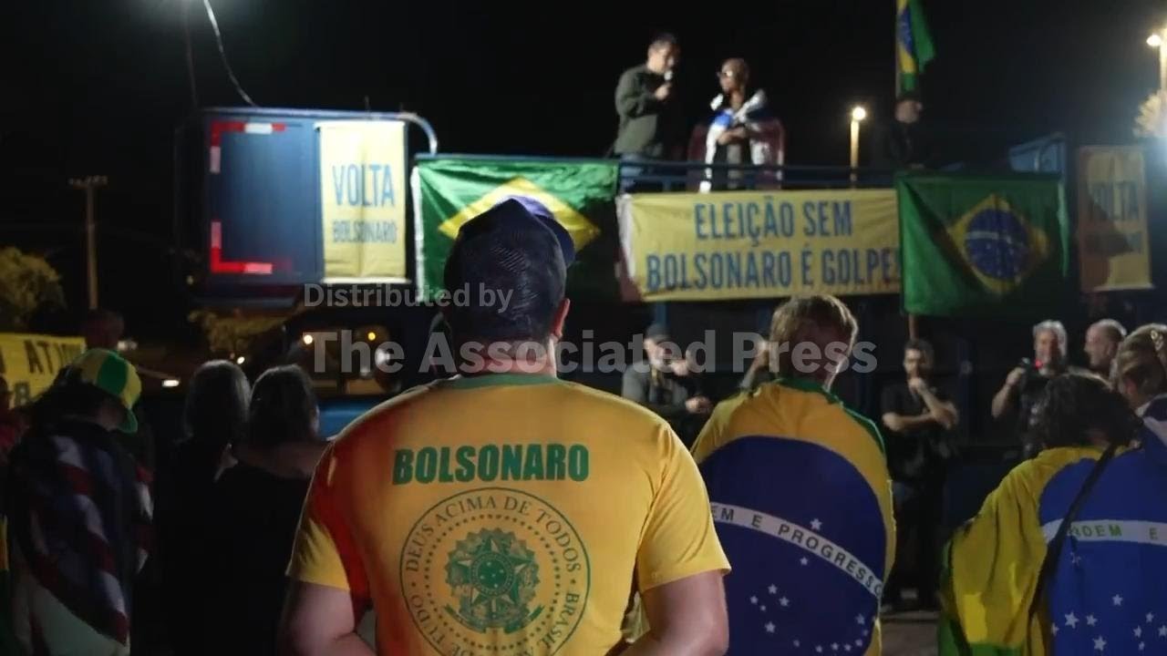 Supporters of former Brazilian president Jair Bolsonaro pray ahead of his trial