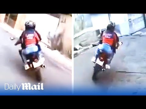 Motorcyclist in high-speed police chase through Brazil’s favelas with woman on the back of his bike