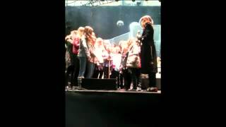 Florence Welch singing with some lucky choristers