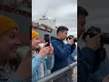 Massive Cargo Ship "Sea Vanguard" Guided by Tugboats in Busy Harbor