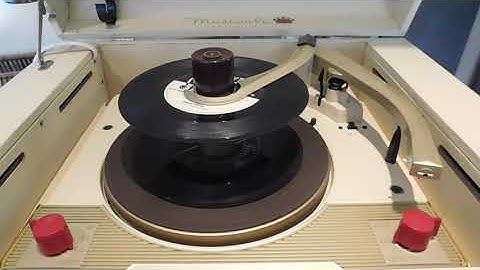 Webcor Musical portable automatic record player playing a stack of 45s.