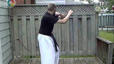 Taekwondo: Hapkido: Foundations: Jumping back-fist back strike in x-stance (front view)