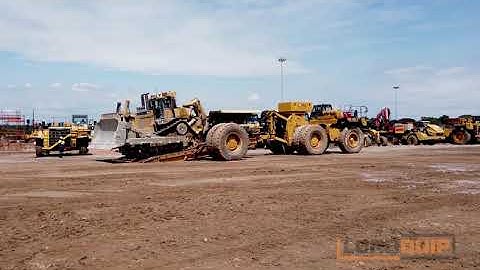 Unloading D10 dozer from tilting low loader