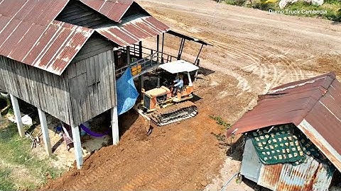 Incredible!! skill operator bulldozer pushing soil  around the house and dump truck unloading soil