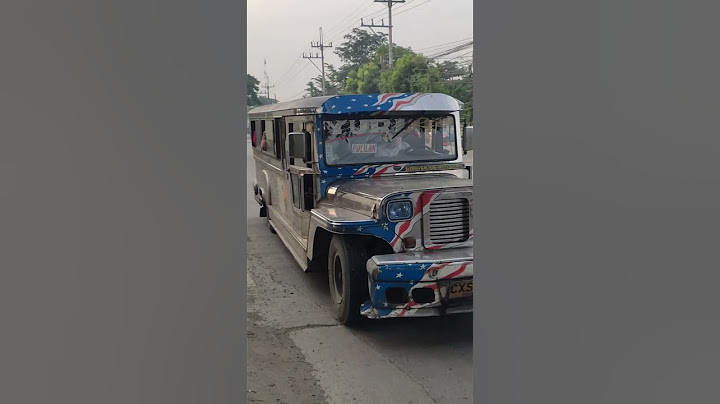 THIS JEEPNEY IS DECORATED WITH FLAG OF THE USA PAINTING IN FRONT!!