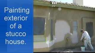 Painting exterior of a house with an airless sprayer.