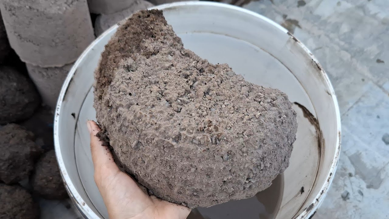 New video Black gritty charcoal crumbling in water bucket satisfying 