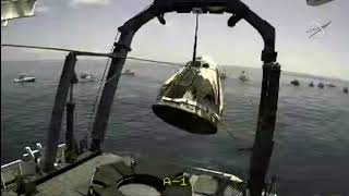 Capsule carrying astronauts Bob Behnken and Doug Hurley hoisted onto ship