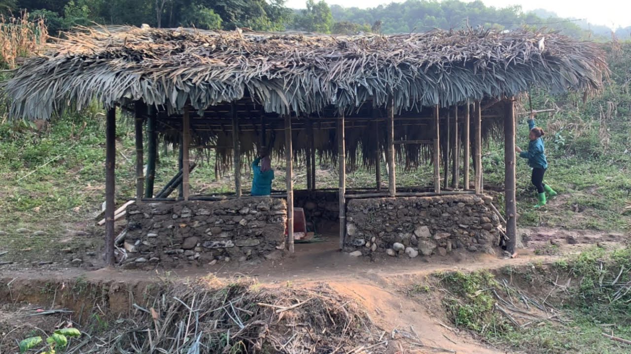 The young girl and her grandmother built a bamboo wall frame for their house.