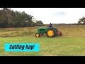 Cutting hay with a New Holland sickle bar mower.