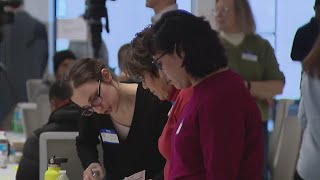 Migrants get help with forms needed for work permits at Loop event