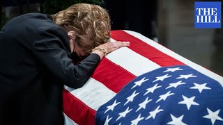 Elizabeth Dole Touches Casket Of Late Husband Bob Dole As He Lies In State