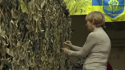 Ukrainian volunteers weave camouflage nets