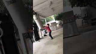 Boy hits boxing bag then it swings back and hits his head causing him to fall