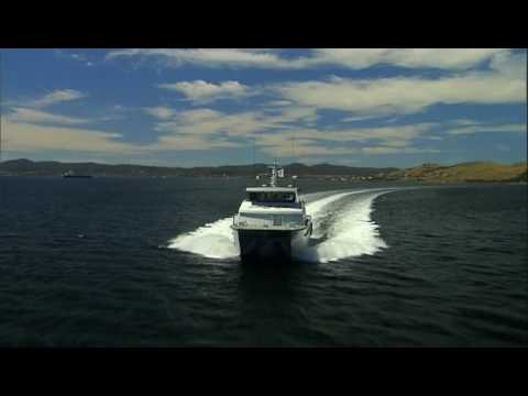 www.offshoreunlimited.com.au Offshore Unlimited's new 24m catamaran offshore support boat built at the new Richardson Devine Marine facility in Hobart, Tasmania. The design is based on Incat Crowthers recent successes in catamaran workboat design, utilising their high carrying capacity hullforms and capitalising on their experience to develop durable aluminium structures. "Unlimited" is a 24.0m high speed catamaran workboat capable of carrying 50 tonnes of deadweight and a service speed of 26 knots. The main deck, has a carrying capacity of 24 tonnes, arranged for multiple uses and includes a moonpool for exploration services and the ability to carry a 20ft container. The deck is serviced by a Heila deck crane capable of lifting 3.5 tonnes, a remote release tow hook with a 15 tonne SWL and a 2 tonne SWL capstain. The main accommodation is located fwd and contains space for a crew of 12. The main deck cabin houses the galley and crew mess area, along with two crew cabins for the senior crew. Wash facilities are also located on this deck, one accommodating laundry facilities. Junior crew cabins are located in both the port and starboard hull with a large pantry located aft in the port hull. Day accomodation and seating is provided for up to 38 persons. The wheelhouse is located on the upper deck and features all round visibility from the helm seat. Crew and passenger seating is provided around the perimeter of the cabin. Two wing control stations are fitted forward on <b>...</b>